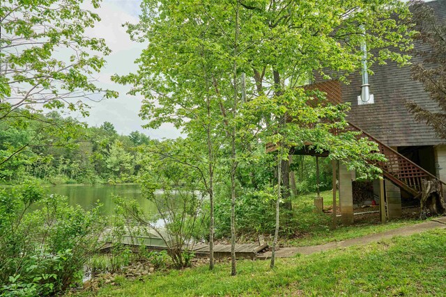 1 Kiwanie Crk, Cherokee Village, AR 72542 - view of yard with stairway, a water view, and a wooded view