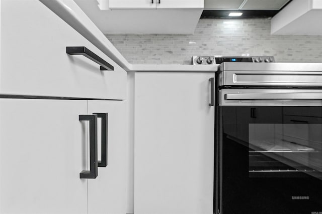 3113 W 11th, Little Rock, AR 72204 - kitchen view of electric range, light countertops, and white cabinetry