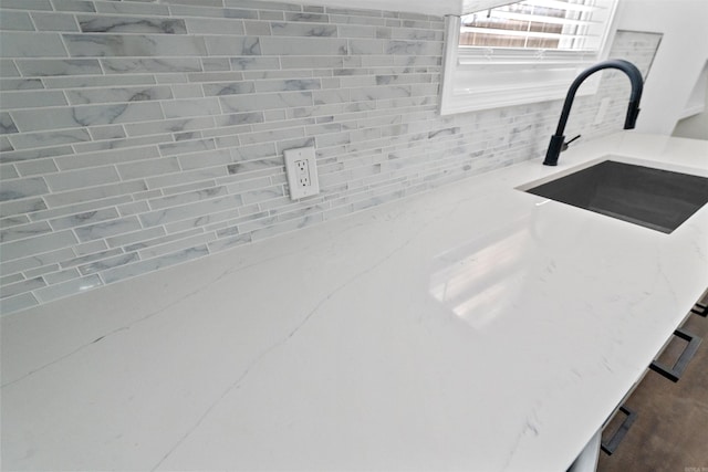 3113 W 11th, Little Rock, AR 72204 - kitchen view of backsplash, a sink, and light stone countertops