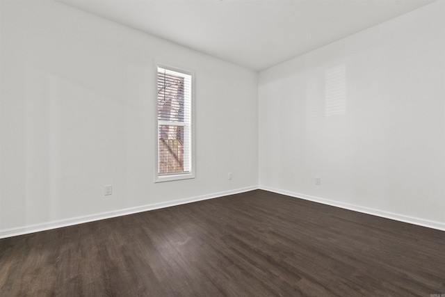 3113 W 11th, Little Rock, AR 72204 - spare room with dark wood-type flooring and baseboards