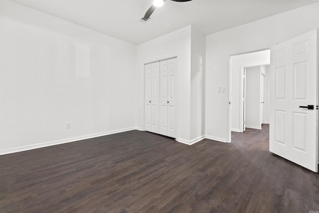 3113 W 11th, Little Rock, AR 72204 - unfurnished bedroom featuring dark wood-style flooring, baseboards, a closet, and a ceiling fan