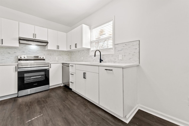 3113 W 11th, Little Rock, AR 72204 - kitchen featuring appliances with stainless steel finishes, under cabinet range hood, a sink, dark wood-style floors, and light countertops