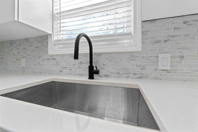 3113 W 11th, Little Rock, AR 72204 - kitchen view of a sink, backsplash, and light countertops