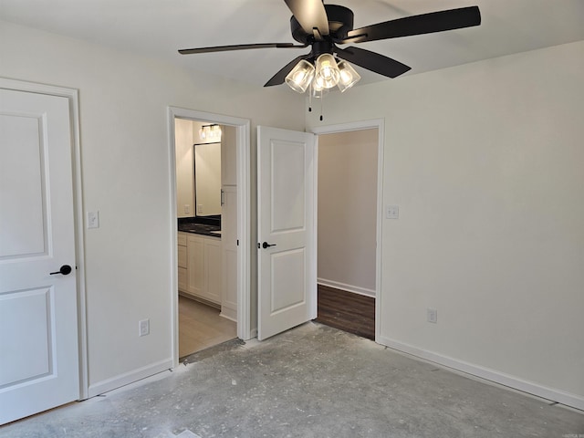 252 Kelton St, Hensley, AR 72065 - unfurnished bedroom featuring baseboards, concrete flooring, ensuite bath, and a ceiling fan