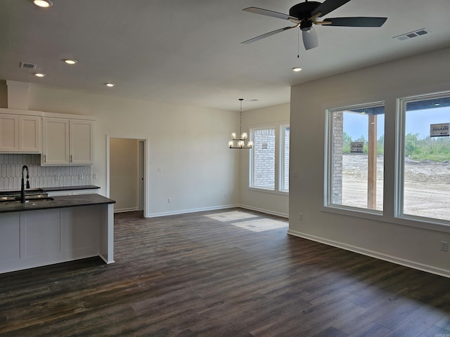 252 Kelton St, Hensley, AR 72065 - kitchen featuring a sink, dark countertops, a chandelier, dark wood-type flooring, and a ceiling fan