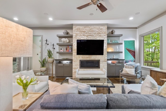 145 Cove Creek Ct, Little Rock, AR 72211 - living area with a fireplace, wood finished floors, ceiling fan, ornamental molding, and recessed lighting