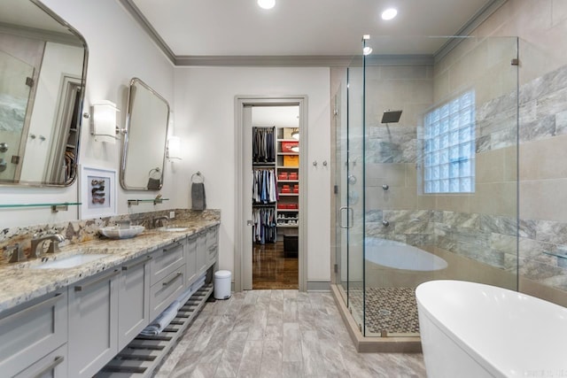 145 Cove Creek Ct, Little Rock, AR 72211 - full bath with a stall shower, double vanity, a freestanding tub, ornamental molding, and a spacious closet