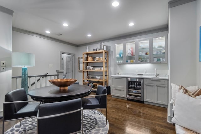145 Cove Creek Ct, Little Rock, AR 72211 - dining area with wine cooler, wet bar, ornamental molding, dark wood-type flooring, and recessed lighting