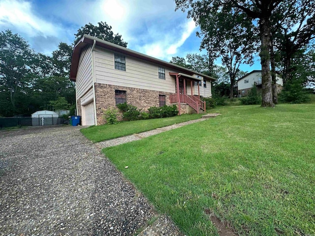 809 Emerald Gardens Dr, North Little Rock, AR 72118 - view of property exterior featuring brick siding, an attached garage, driveway, and a lawn