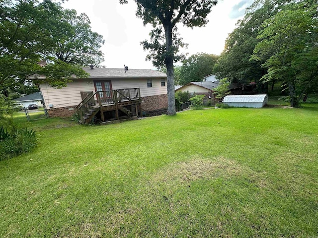 809 Emerald Gardens Dr, North Little Rock, AR 72118 - view of yard featuring stairway, a wooden deck, a storage unit, french doors, and an outdoor structure
