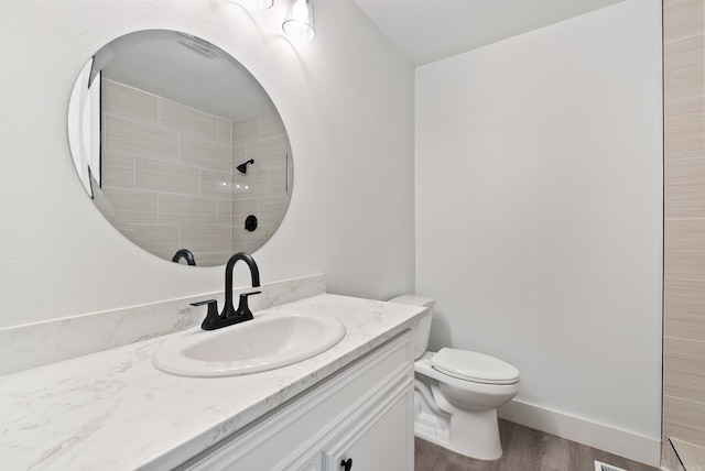 312 Eubanks Rd, Jacksonville, AR 72076 - full bath featuring tiled shower, wood finished floors, toilet, and vanity