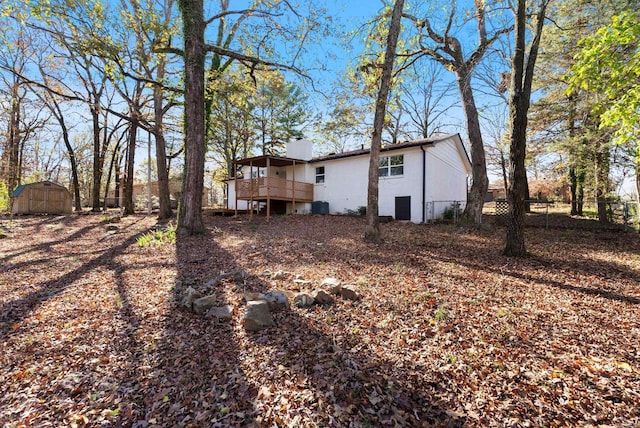 312 Eubanks Rd, Jacksonville, AR 72076 - back of property with a wooden deck, a shed, fence, and an outdoor structure