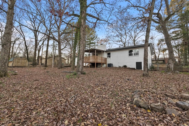312 Eubanks Rd, Jacksonville, AR 72076 - rear view of house with fence, an outbuilding, an exterior structure, a wooden deck, and central AC unit