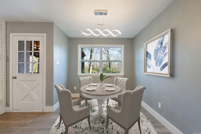 312 Eubanks Rd, Jacksonville, AR 72076 - dining space featuring light wood finished floors, baseboards, and a chandelier