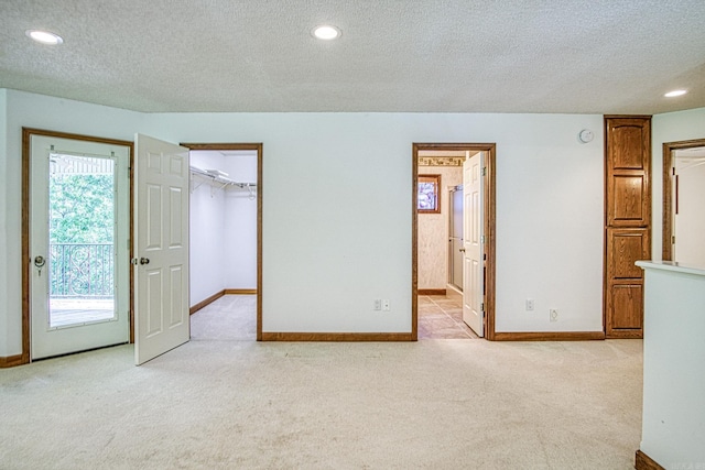 16 Zutano Ln, Hot Springs Village, AR 71909 - unfurnished bedroom with a textured ceiling, light colored carpet, access to exterior, baseboards, and recessed lighting