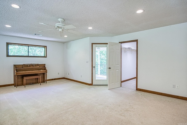 16 Zutano Ln, Hot Springs Village, AR 71909 - unfurnished living room featuring light carpet, ceiling fan, a textured ceiling, baseboards, and recessed lighting