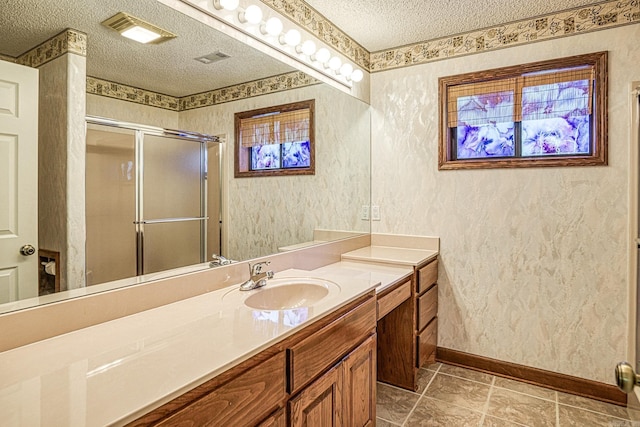 16 Zutano Ln, Hot Springs Village, AR 71909 - full bathroom featuring a textured ceiling, baseboards, a shower stall, and vanity