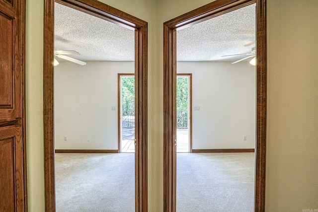 16 Zutano Ln, Hot Springs Village, AR 71909 - hallway featuring a textured ceiling, carpet floors, and baseboards