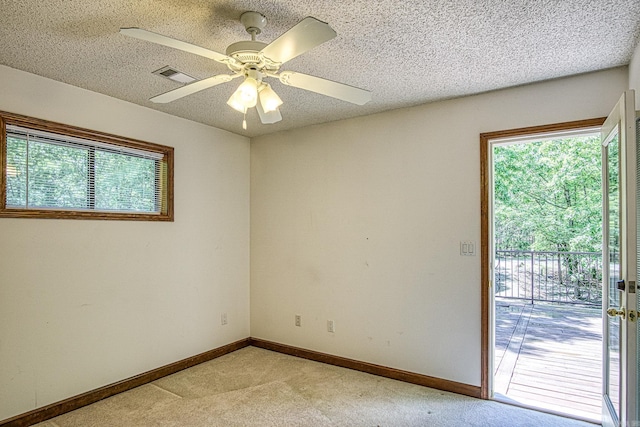 16 Zutano Ln, Hot Springs Village, AR 71909 - spare room with light colored carpet, plenty of natural light, baseboards, a ceiling fan, and a textured ceiling