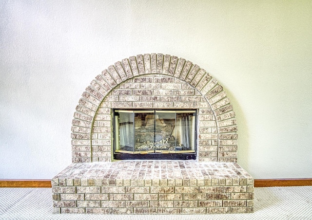 16 Zutano Ln, Hot Springs Village, AR 71909 - detailed view of a fireplace, baseboards, and carpet flooring
