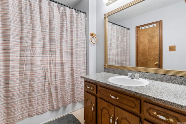 23 S Summit Dr, Cabot, AR 72023 - bathroom featuring tile patterned floors, a textured ceiling, vanity, and shower / tub combo