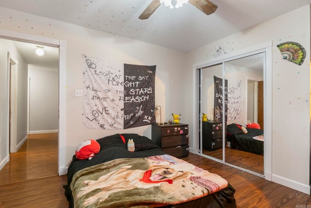 23 S Summit Dr, Cabot, AR 72023 - bedroom featuring wood finished floors, a closet, a textured ceiling, and baseboards