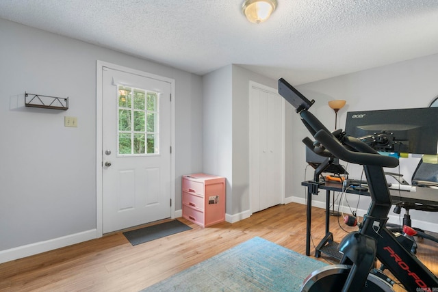 23 S Summit Dr, Cabot, AR 72023 - workout room with light wood-style floors, a textured ceiling, and baseboards