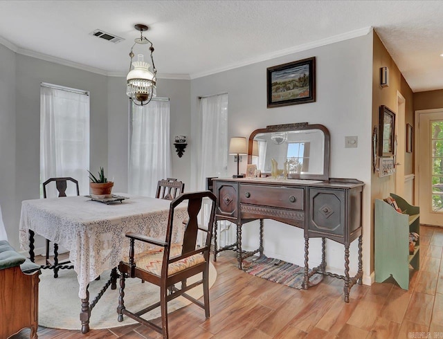 301 Kleinshore Rd Unit 19, Hot Springs, AR 71913 - dining space with light wood-type flooring, a chandelier, and crown molding