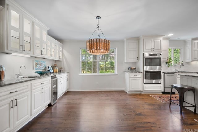 2820 N Rodney Parham Rd, Little Rock, AR 72212 - kitchen featuring stainless steel appliances, healthy amount of natural light, beverage cooler, light stone counters, and recessed lighting