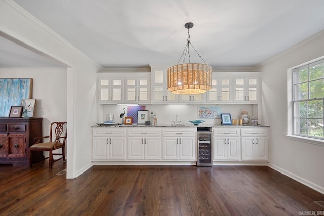 2820 N Rodney Parham Rd, Little Rock, AR 72212 - indoor wet bar featuring beverage cooler, dark wood finished floors, ornamental molding, and decorative light fixtures