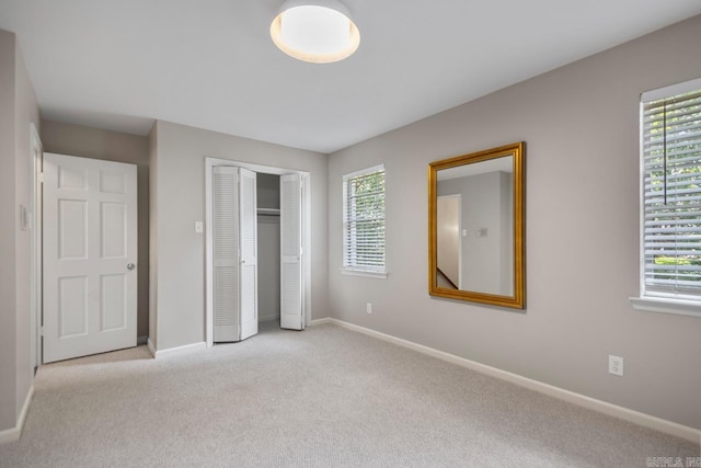 2820 N Rodney Parham Rd, Little Rock, AR 72212 - unfurnished bedroom featuring light colored carpet, multiple windows, and a closet