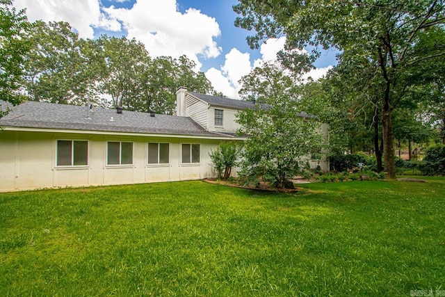 2820 N Rodney Parham Rd, Little Rock, AR 72212 - rear view of house with a lawn, a chimney, and a shingled roof