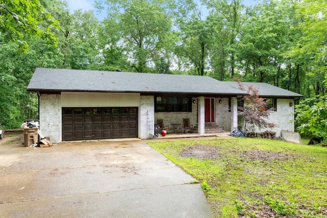 7104 Foxrun E End Dr, Mabelvale, AR 72103 - view of front of house featuring a porch, a garage, concrete driveway, and brick siding