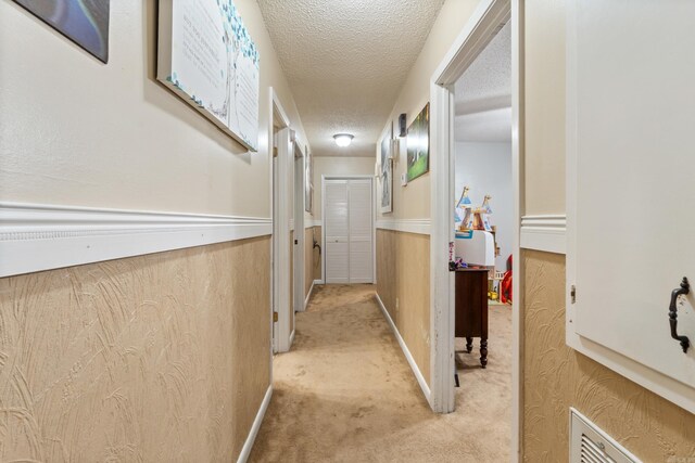 7104 Foxrun E End Dr, Mabelvale, AR 72103 - corridor featuring light carpet and a textured ceiling
