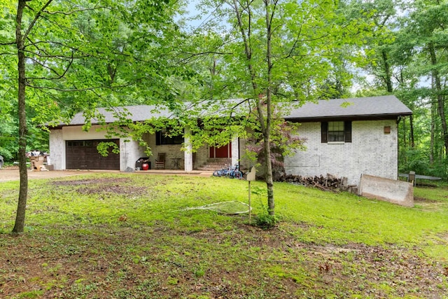 7104 Foxrun E End Dr, Mabelvale, AR 72103 - view of front facade with a garage, a front lawn, brick siding, concrete driveway, and a shingled roof