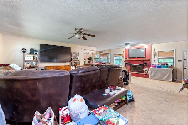 7104 Foxrun E End Dr, Mabelvale, AR 72103 - living area with a ceiling fan, plenty of natural light, carpet flooring, a textured ceiling, and a brick fireplace