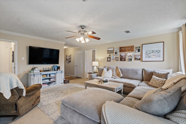 living area with light colored carpet, crown molding, a ceiling fan, a textured ceiling, and baseboards