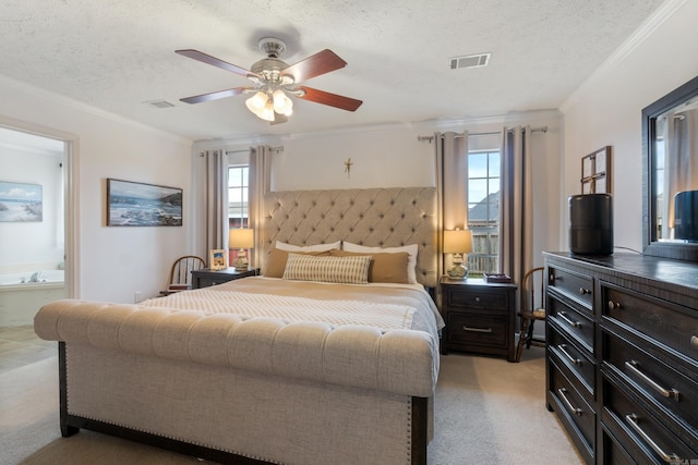 bedroom featuring light colored carpet, ornamental molding, a textured ceiling, ceiling fan, and connected bathroom