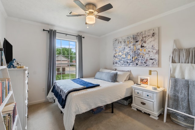 carpeted bedroom featuring ornamental molding, ceiling fan, and baseboards