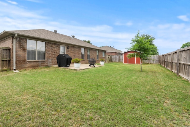 view of yard featuring a storage unit, a patio, and an outdoor structure