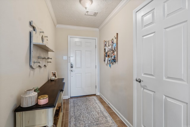 doorway to outside with a textured ceiling, crown molding, baseboards, and dark tile patterned flooring