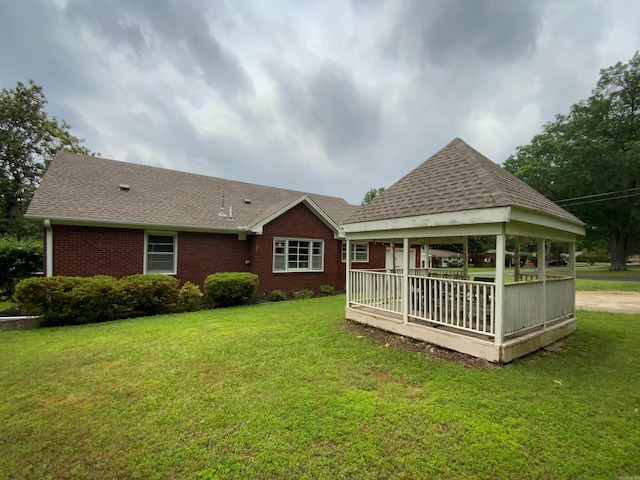 1400 Tulip Ave, Searcy, AR 72143 - rear view of house featuring brick siding, a yard, a shingled roof, and a gazebo