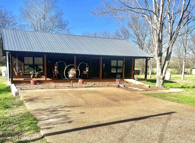 view of front of house with a porch and metal roof