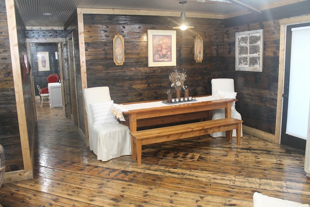 dining area featuring hardwood / wood-style floors and wooden walls