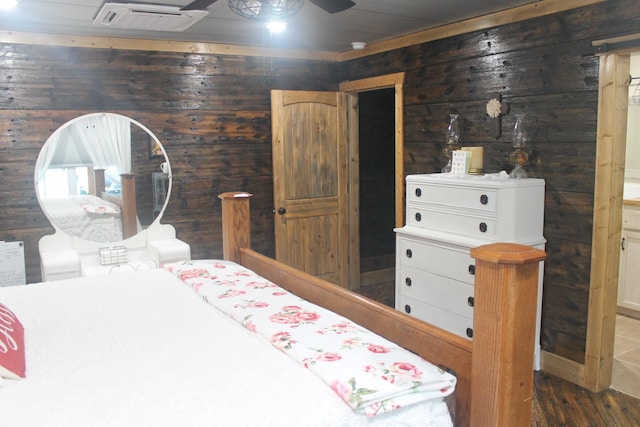 bedroom featuring wood walls and dark wood finished floors