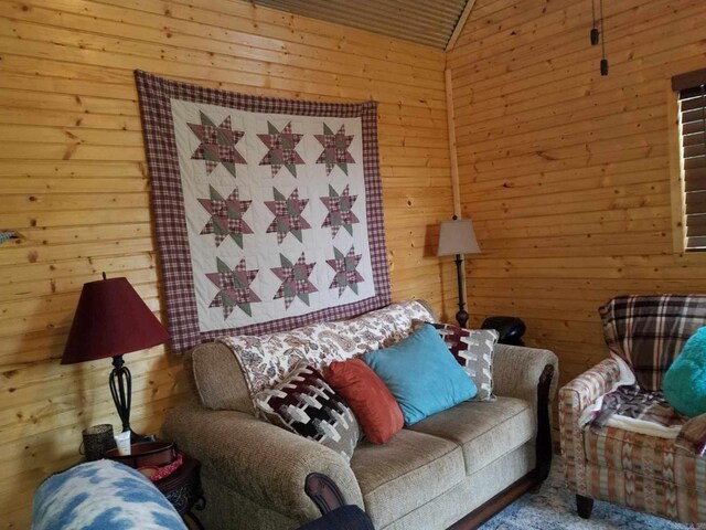 3227 Red Bluff Rd, Marshall, AR 72650 - living room featuring wood walls, vaulted ceiling, and carpet flooring