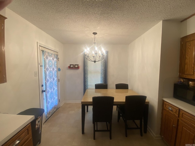 111 Dales Dr, Jacksonville, AR 72076 - dining area featuring a chandelier, a textured ceiling, and light flooring