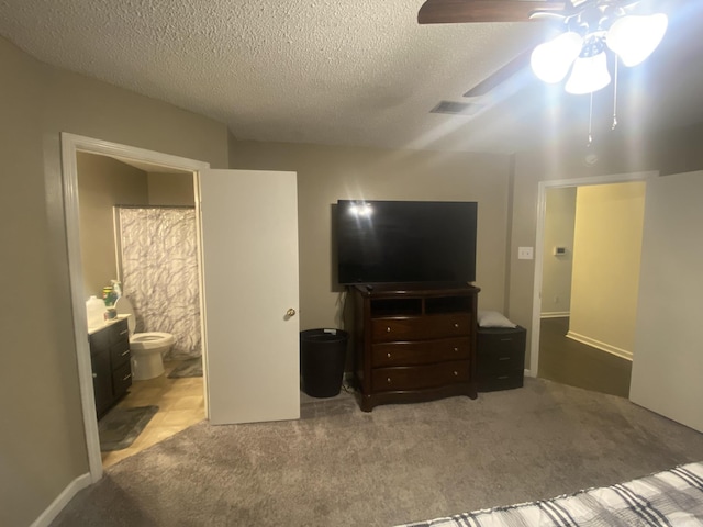 111 Dales Dr, Jacksonville, AR 72076 - carpeted bedroom with a textured ceiling, ensuite bathroom, and a ceiling fan