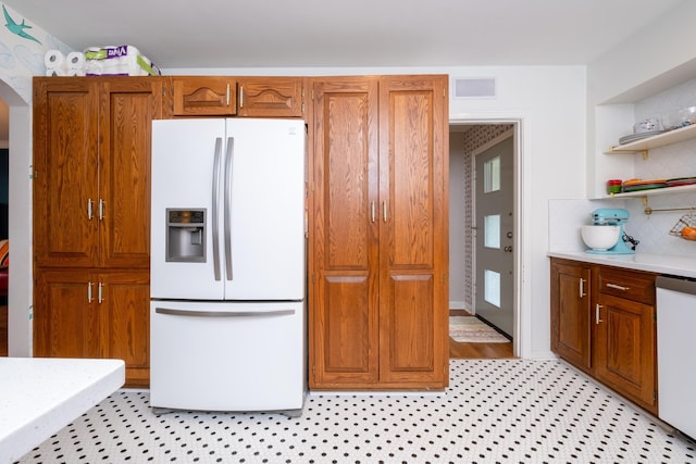 375 Goshen Ave, North Little Rock, AR 72116 - kitchen featuring white appliances, light countertops, brown cabinetry, open shelves, and backsplash