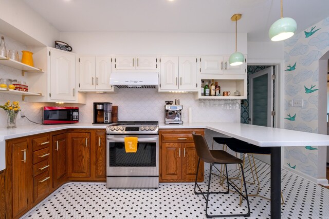 375 Goshen Ave, North Little Rock, AR 72116 - kitchen with stainless steel gas stove, open shelves, under cabinet range hood, light countertops, and a breakfast bar area